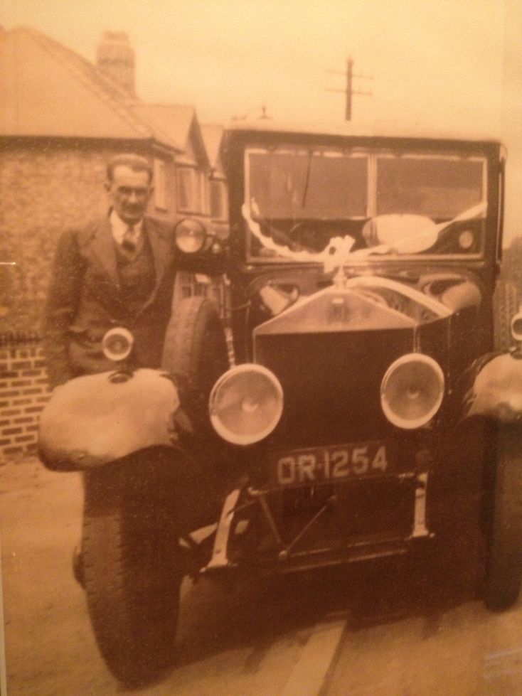 Funeral director standing next to car